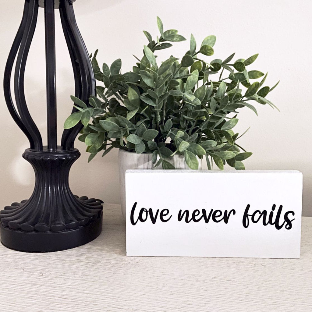 Love Never Fails Wood Sign